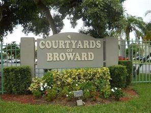 This corner unit is located on the 1st floor. The laundry room & elevators are conveniently located around the corner.  2 Bed 2 Bath with the kitchen to the right and a large large family room with sliding glass doors and a screened porch. 2 walk-in closets. Courtyards of Broward is in a walking distance to Hamptons Pines Park, Publix, Broward Meat & Fish, Walmart & multiple shopping plazas.