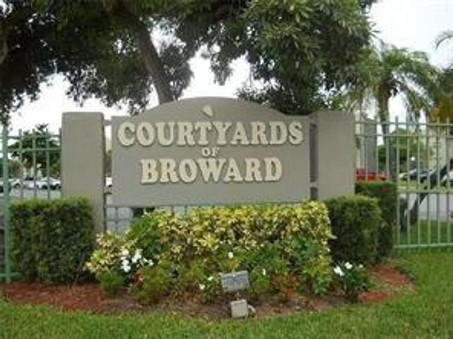This corner unit is located on the 1st floor. The laundry room & elevators are conveniently located around the corner.  2 Bed 2 Bath with the kitchen to the right and a large large family room with sliding glass doors and a screened porch. 2 walk-in closets. Courtyards of Broward is in a walking distance to Hamptons Pines Park, Publix, Broward Meat & Fish, Walmart & multiple shopping plazas.