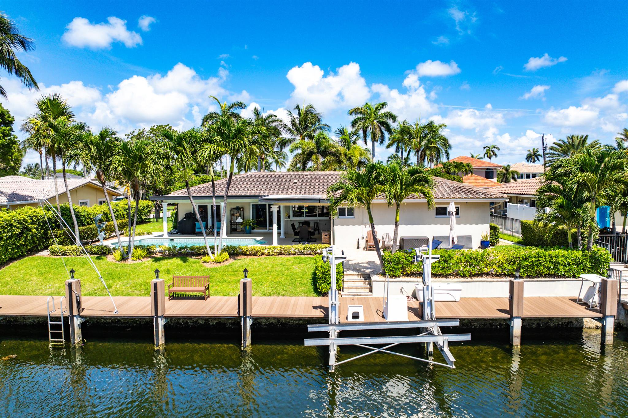 Boater's dream in an unbeatable location! This breathtaking Venetian Isles deepwater estate offers 90 feet of prime water frontage with a rare vessel turnabout and direct access to the Intracoastal, Hillsboro, and Boca inlets--no fixed bridges. Meticulously maintained and renovated with pride of ownership, the 3-bed, 2-bath home features an open-concept layout, a centrally located kitchen with custom cabinetry, tile flooring throughout, and high-impact windows and doors that frame sweeping water views. A charming bay window fills the living space with natural light, enhancing the home's warm, inviting atmosphere. Indoor and outdoor living blend seamlessly, leading to a private resort-style retreat with covered and open patio areas, rare green space, and lush tropical landscaping.