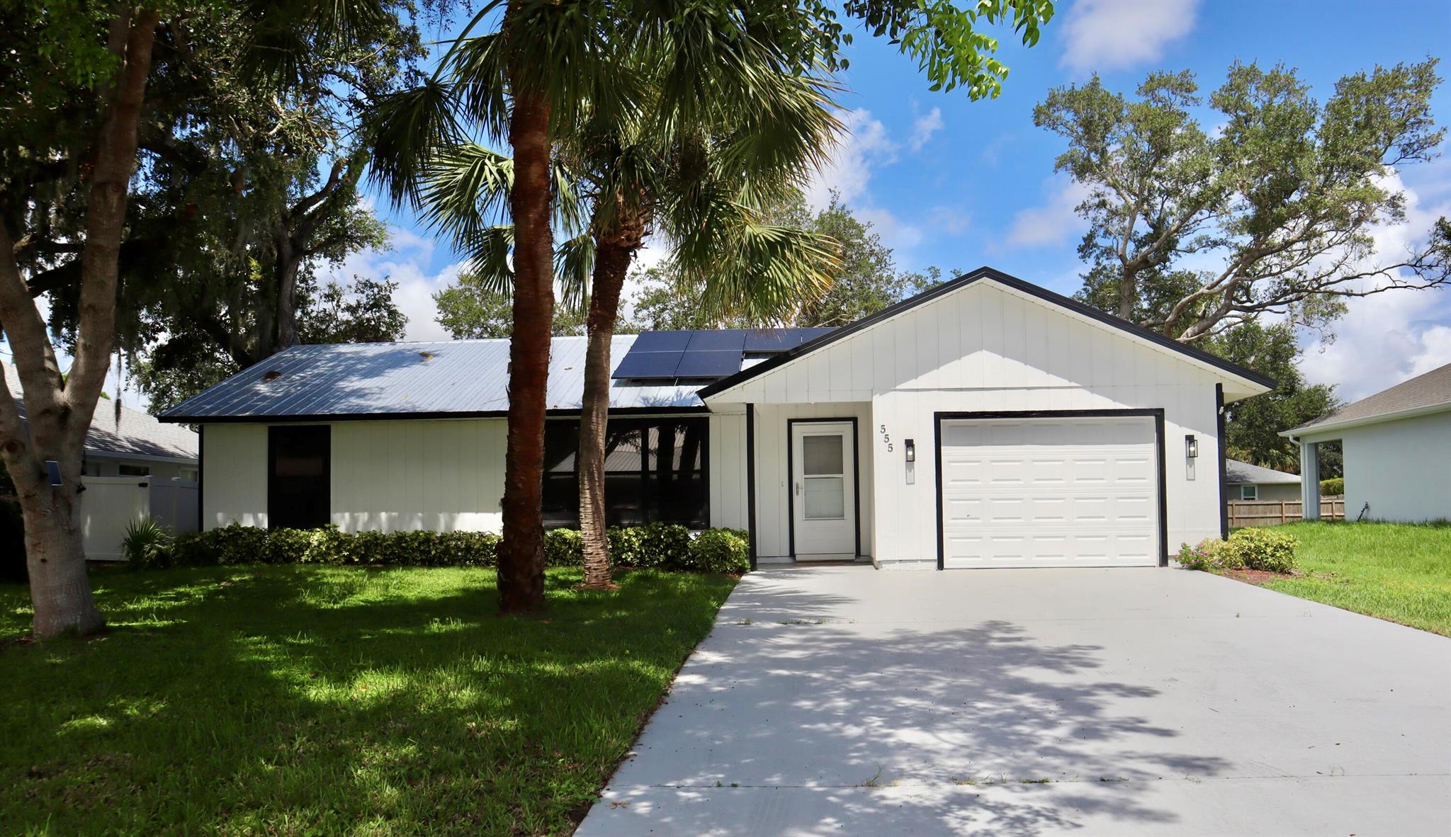 Welcome to this BEAUTIFULLY just REMODELED ENERGY EFFICIENT HOME, modern and PREMIUM FINISHES. No HOA, on a city water. METAL ROOF along with SOLAR PANELS from 2022 (PAID OFF) , Gas Stove & Water Heater on a leased propane tank , electric service panel from 2022, A/C and automatic garage door from 2024 . Enjoy a stylish and spacious kitchen with new upgraded appliances, soft closing cabinets and Quartz island countertop. New waterproof flooring vinyl throughout, and a refreshed and modern bathrooms. Oversized, screened patio. Freshly painted inside/out including driveway and garage.This home is just minutes from schools, grocery stores , downtown Vero Beach and the beach. Don't miss out on this gem.
