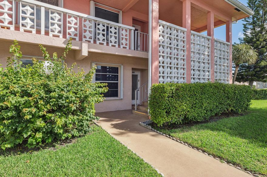 Discover the charm and convenience of this beautifully updated two bedroom/two bath, first floor corner unit in the desirable Pines of Delray North community. Bathed in natural light, this inviting residence boast serene garden views. Thoughtfully designed for modern living, the unit features a split bedroom plan with an open living space. Accessibility is prioritized with wheelchair friendly entry and layout, making it an ideal choice for all lifestyles. Accordian shutters for hurricane protection, ensuring peace of mind during storm season. Ample parking located right near the front entrance. Residents enjoy an array of exceptional community amenities, including two sparkling heated pools, pickeball courts, fitness room and two clubhouses perfect for social gatherings and events.