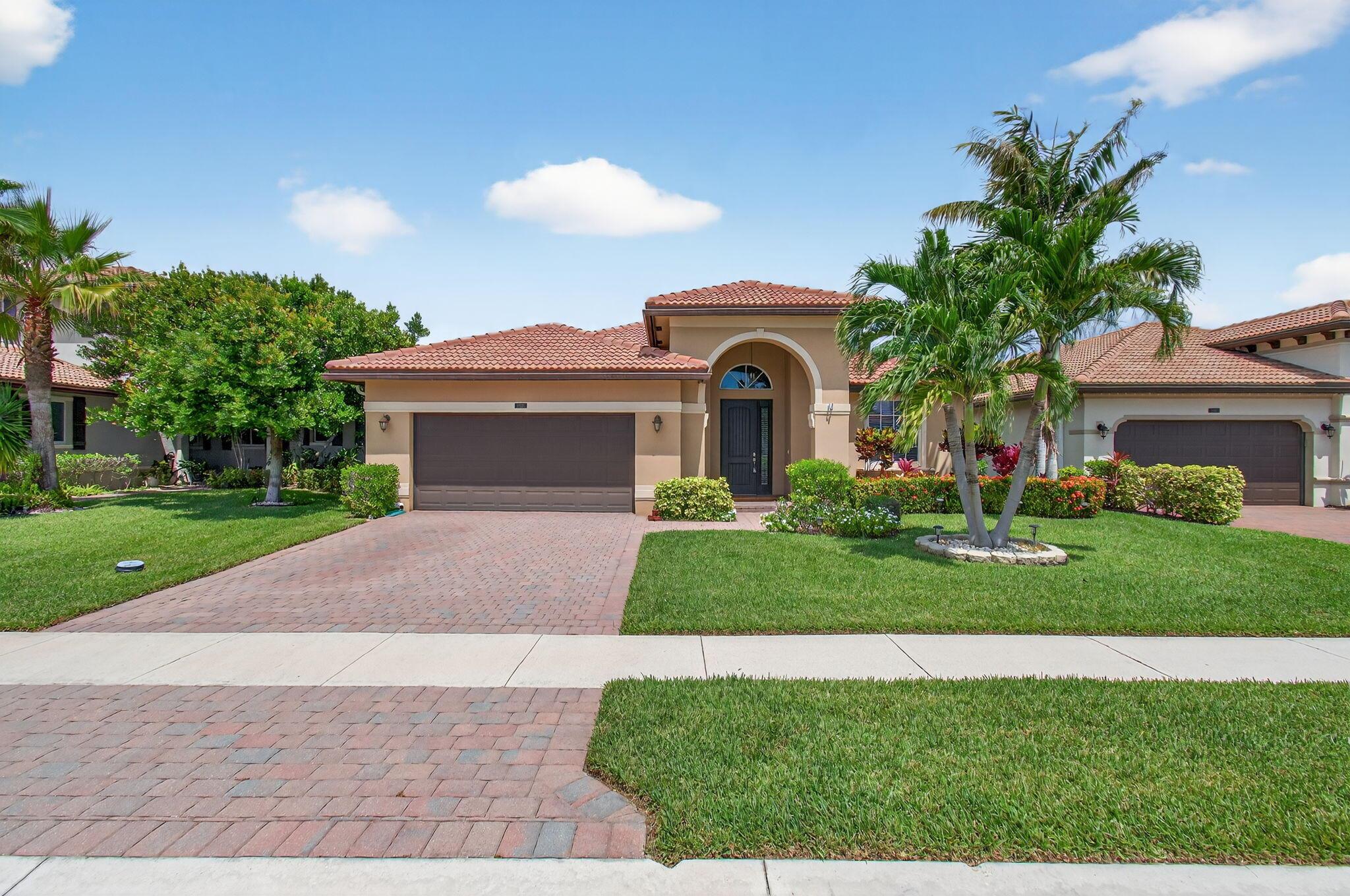 Step into this 4 bedroom, 3 bathroom home and you feel the comfort and sophistication in this meticulously-maintained space situated at 7155 Prudencia Drive, Greenacres, FL. Appreciate peace of mind knowing this property, erected in 2014, was built to withstand nature's toughest events, with durable hurricane windows installed throughout the home (glass block windows that augment its architectural appeal, use panels instead). Enjoy the wonderful affinity for outdoor living with an exquisite salt water pool, and a stunning lake view. The pool invitingly stands as the sparkling crown jewel of the property, a refreshing retreat on warm summer days or moonlit evenings. The stunning lake view provides peace and tranquility, a true Florida experience.