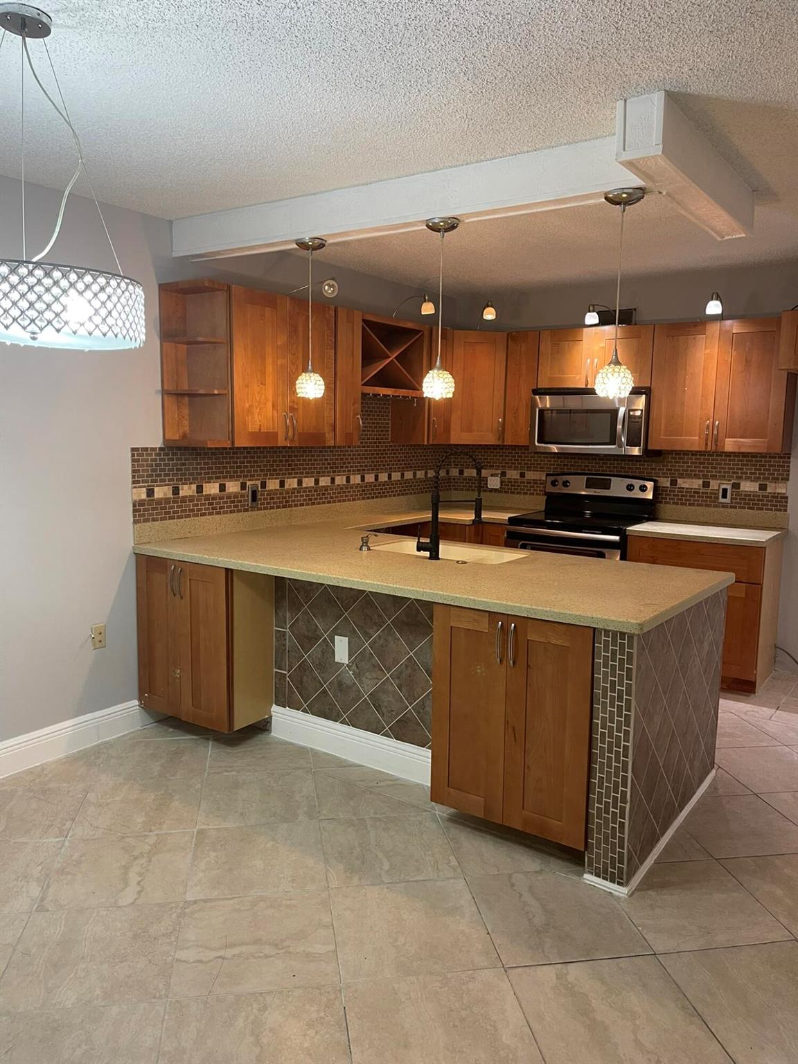 Fantastic Opportunity in Sandalwood Lakes! Centrally Located 2/2.5 Townhome With Updates Kitchen With Shaker Style Cabinets, Solid Surface Counters, Tile Backsplash, and Stainless Appliances Updates to Baths. Neutral Tile Flooring throughout. Large Open Patio for Outdoor Living with canopy. Close to All of the Fun & Action of Downtown West Palm Beach and the new Tanger Outlets. Community Offers Pools, Tennis, Playground, and Dog Park.