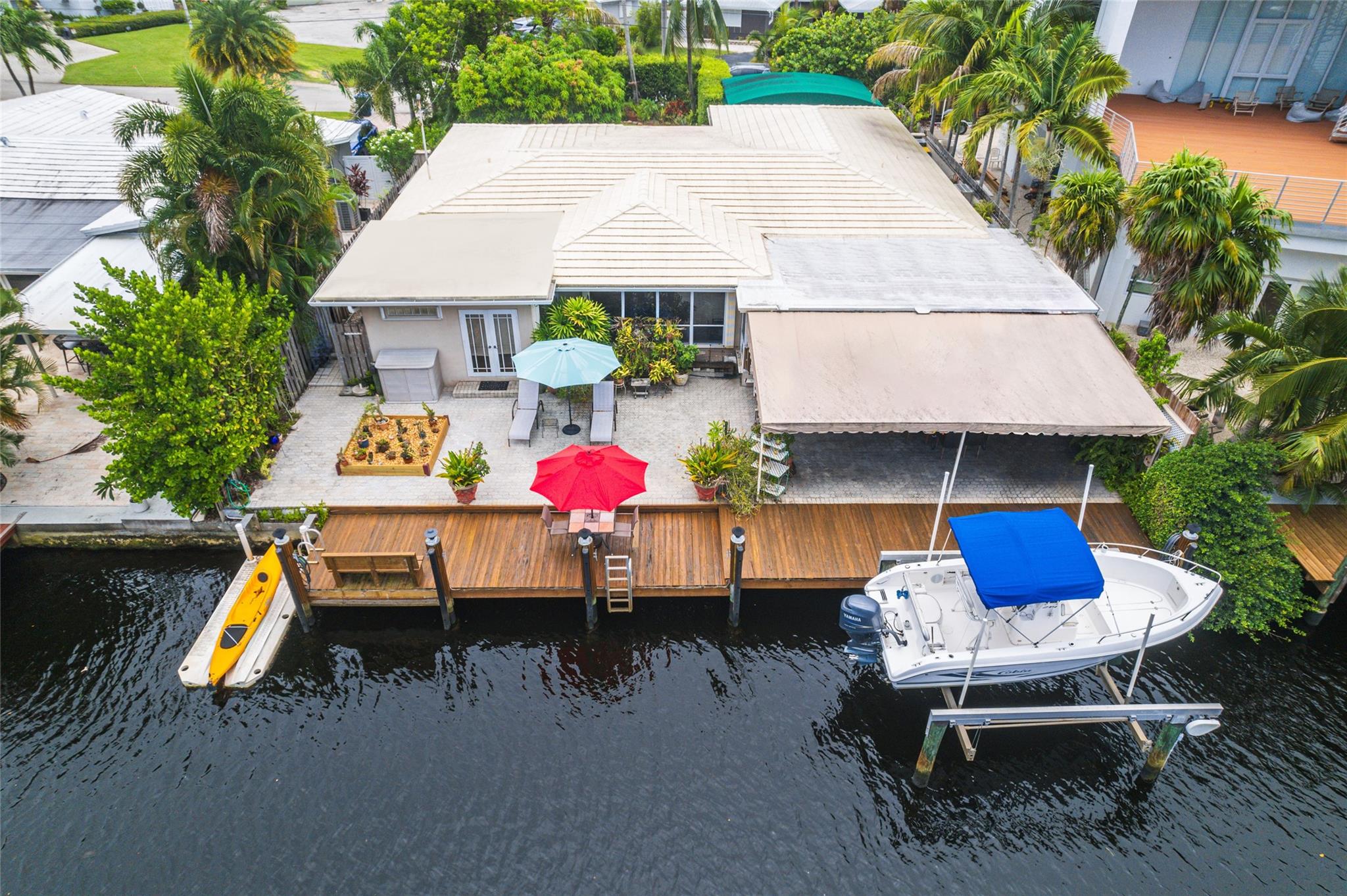 Boater's Dream House in the heart of Wilton Manors! Step inside this spacious 4 bedroom, 3 bathroom home with custom kitchen, abundance of closets and storage space, as well as a 2 car garage. Enjoy the seclusion offered by lush landscaping, fruit trees and orchids in your new oasis. The incredible backyard boasts a 60 ft private dock, boatlift, floating dock, ocean access with 2 fixed bridges, and a stunning orchid arbor. Situated on a tranquil cul-de-sac street, close to dining, shopping, entertainment on Wilton Drive, and nearby beaches and parks, this is the epitome of South Florida living at its finest.