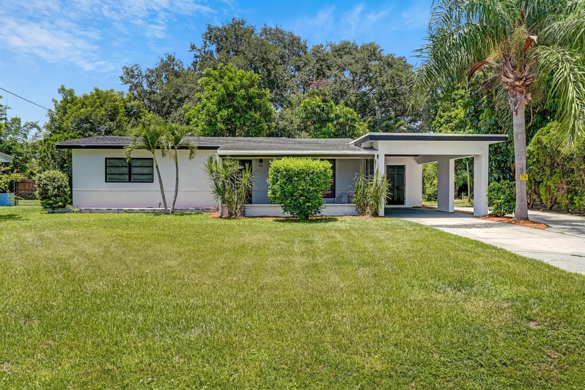 Charming Florida home 3 bedroom, 1 bath that features a 1 car carport, RV-Boat driveway, outdoor shower, spacious screened patio, terrazzo floors, midcentury features have been left in place to add to the charm of this home. Spacious bedrooms with plenty of closet space. Lush landscaping and walking distance to the John B Park, tennis courts, and activity center. Minutes to shopping, dining, medical and the beach.