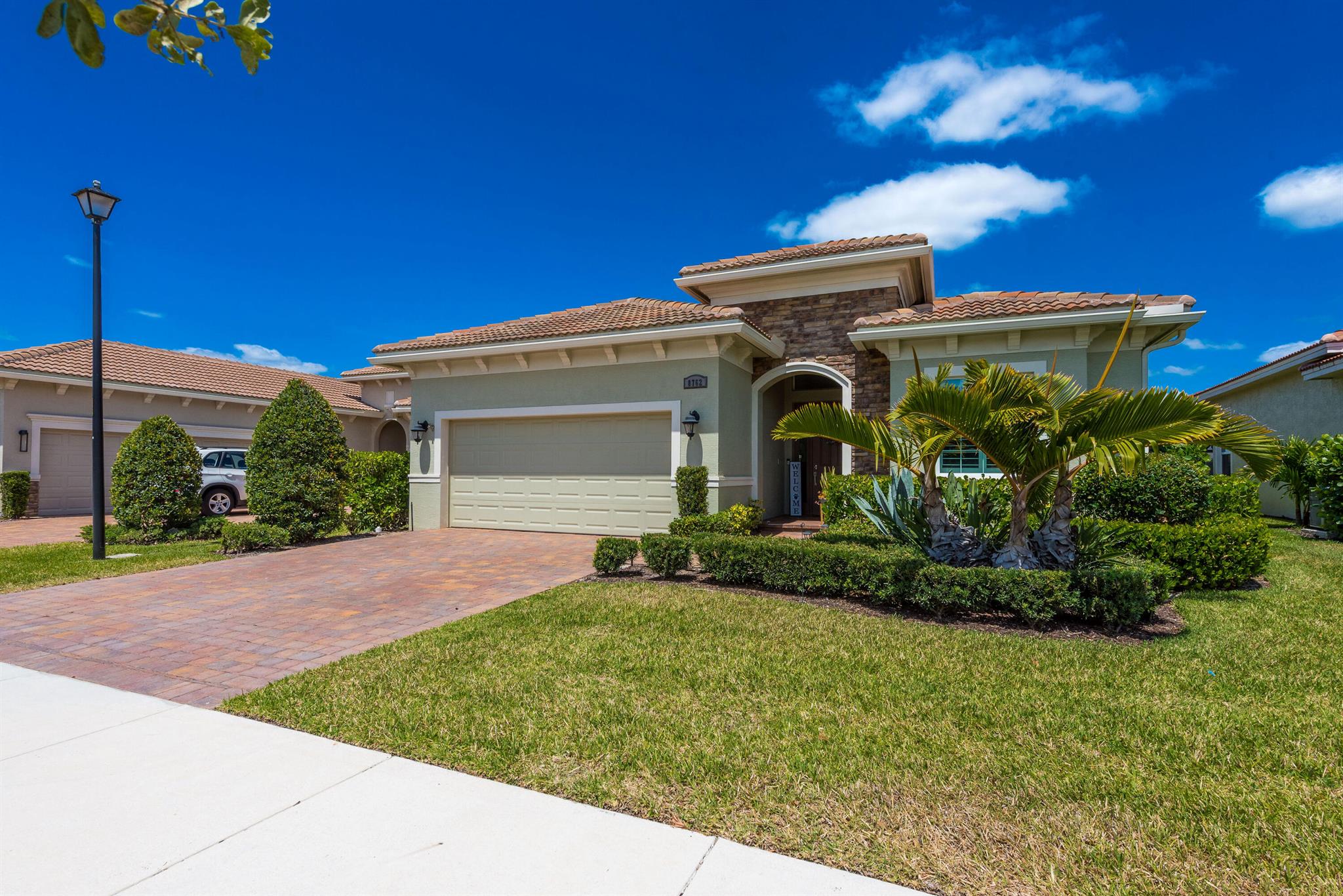 Welcome to your dream home in PGA Village Verano! This 3BR/3BA beauty features an open floor plan, volume ceilings, plantation shutters, impact windows, and elegant finishes throughout. The kitchen flows into spacious living and dining areas, ideal for entertaining. Enjoy outdoor living with a screened porch and private fenced patio. Includes a laundry room with sink, whole-house water filtration, and paid-off solar panels at closing. The Tonal smart gym conveys. The primary suite offers walk-in closets and a luxurious en-suite bath. HOA covers lawn care, cable, internet, and more. Enjoy resort style amenities at Club Talavera include pools, clubhouse, fitness center, tennis, pickleball, and much more.This home is ideally located near I-95, shopping, dining, and top-rated schools.