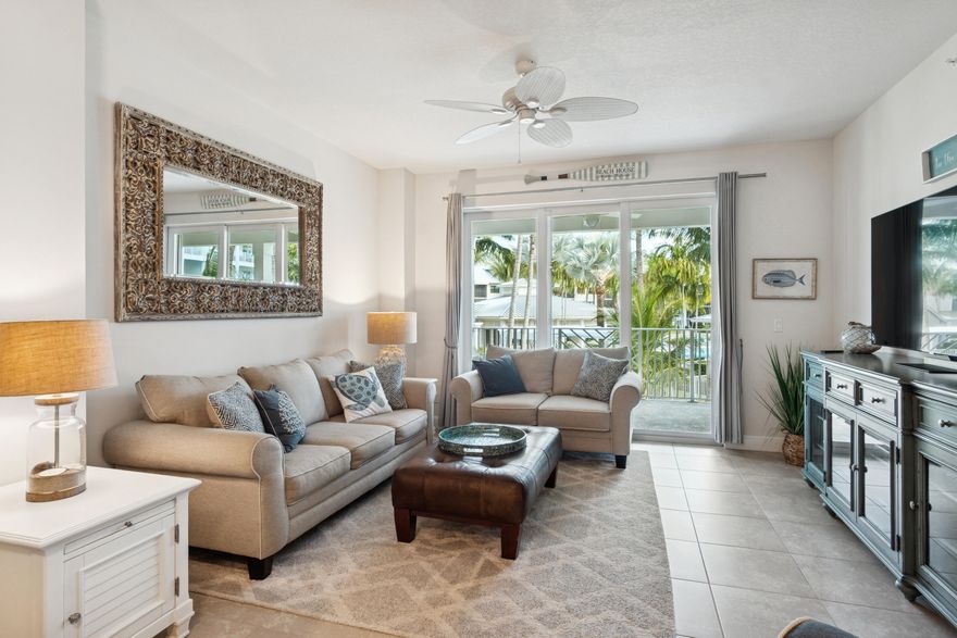 Move right in to this beautiful, fully furnished, turn-key, 2nd floor unit with a resort view at Bay Colony,  This fabulous unit built in 2015, boasts 1,259 sq, ft. of living space with 2 bedrooms, and 2 full baths.  Ceramic tile floors throughout the living areas with carpet in the 2 spacious bedrooms.  Enjoy the tranquil palm and garden views from the extra-large balcony.  This waterfront community has a private marina with boat sips available for boats up to 50ft.  Resort-style amenities include a heated spa/pool, coastal style clubhouse with full kitchen, tennis & pickle-ball, bocce court, and Kayak racks.  This amazing community is perfectly located close to the beach, excellent schools, fabulous shopping and the best restaurants!  A Must-see and priced to sell!