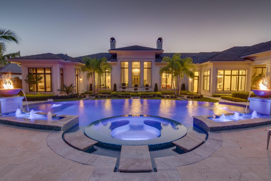 This magnificent custom-built 2015 estate in the private gated community of Old Palm Golf Club offers an intimate, yet comfortable setting. The high level of finishing and overall design choices made are supportive of the idea of creating a well-built and timeless estate. High ceilings and large windows add a natural light to the spacious and bright floor plan. Marble flooring throughout the living spaces, allow the interiors to segue effortlessly from the romantic fireplace living room and formal dining area, to the charming office overlooking the pool area. The inviting gourmet kitchen is equipped with all Wolf appliances and Subzero refrigerators and a butler’s pantry with access to the dining room. The light marble island and counters provide ample prep area and highlight the custom cabinetry, sure to delight any chef. The floor to ceiling sliding doors open and extend the expansive great room onto the large covered lanai for indoor-outdoor living, adding flexibility in layout depending on the occasion. The club room features a climate controlled 1000 bottle wine cellar, pool table, wet bar and the adjacent theatre with recliners, ensure a perfect evening with family and friends. Other highlights include two master suites, his and hers custom walk-in closets, casual dining area, full laundry room, guest house with 2 bedrooms and 2 bathrooms, and more. The covered loggia composes a resort style pool and spa, outside dining area, putting green with synthetic turf, pergola, and 1,050 SF outdoor kitchen, equipped with a grill, wet bar and plenty of prep space. This home is an equipped Smart Home with a full home automation system, Lutron low voltage lighting, Savant audio-visual throughout the home, Hayward outdoor lighting and additional upgrades. Set on a large acre lot, with lush landscaping, adding a serene and natural amount of privacy. This home radiates quality from every inch in and around the house.