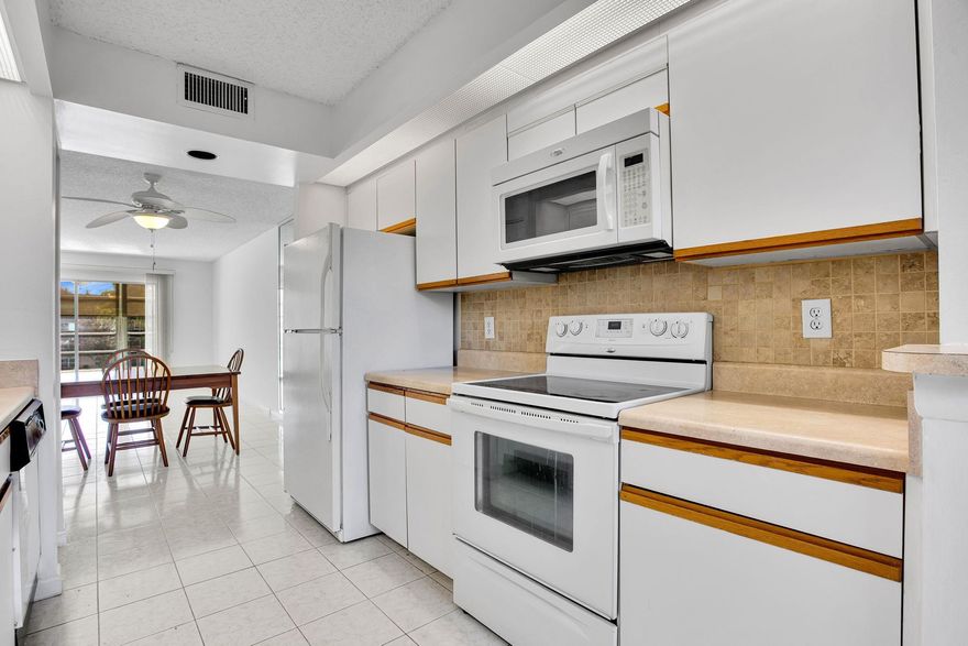 This exceptional apartment features modern living with a striking eastern exposure that fills the space with natural light. The gourmet kitchen integrates seamlessly with the living area, perfect for entertaining and relaxation. The serene bedroom offers ample closet space and a spa-inspired bathroom with newer vanities in both bathrooms. The primary bathroom includes a shower, while the guest bathroom has a tub-and-shower combination. An in-unit washer and dryer adds convenience. The living and dining areas are tiled, and bedrooms have laminatel flooring. Recently painted, the apartment also boasts a new air conditioning unit 2025 and water heater installed 2015.  Enjoy panoramic water views from the glass-enclosed patio with pull-down shades. SEE ALL PHOTOS THEN SEE FOR YOURSELF!