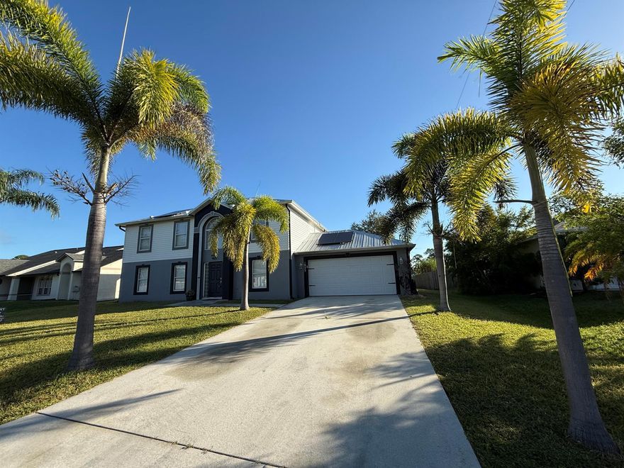 Beautiful and Spacious 4-Bedroom Home for Rent in Port St. Lucie! Beautiful, updated 2-story home centrally located in Port St. Lucie! This lovely property features 4 bedrooms (including a versatile loft/den) and 2.5 bathrooms. The home offers a modern metal roof (2018), gorgeous 24'' tile throughout the first floor, and wood laminate flooring upstairs. Enjoy a stylish kitchen with wood cabinets and stainless steel appliances, plus a formal dining room and a cozy breakfast area that opens to a large family room. The master suite includes an updated, contemporary bathroom with dual sinks, a walk-in glass shower, and a Roman tub, while the second bathroom upstairs has also been beautifully updated. The home boasts a large screened patio with plenty of space for outdoor entertaining or
