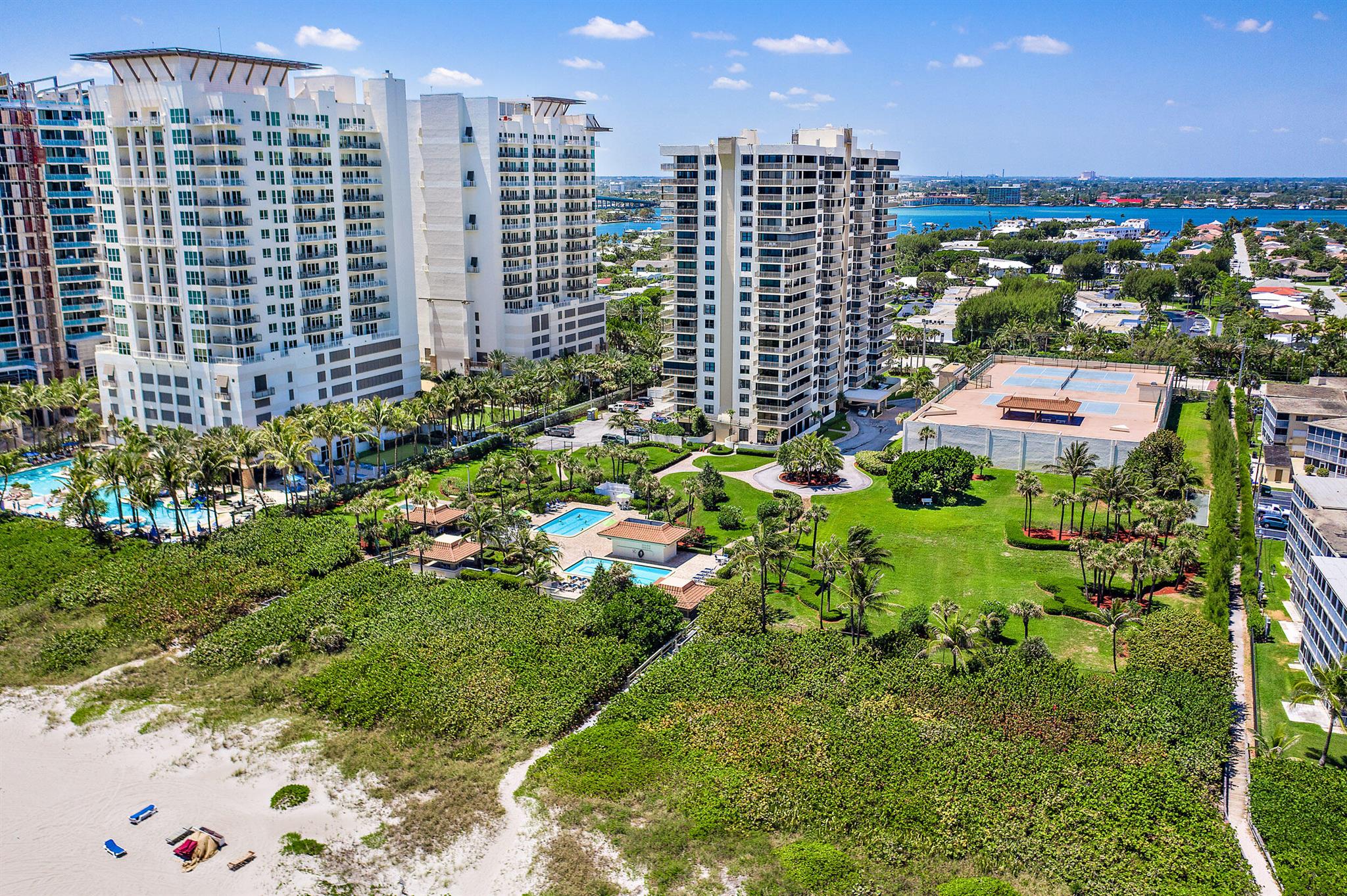 Spacious 2/2 corner over 1,500 SF with water view and HUGE wraparound balcony, light and bright, large open rooms, updated appliances, walk-in closets, Roman tub, walk-in shower, washer/dryer, garage parking, extra storage, concierge. New impact doors just installed and some new furniture. Oceantree has two pools with BBQ areas, tennis, pickle ball, hot tub, fitness center, shuffleboard located at southern end of the island, walk to shops and restaurants. Offered for annual lease, season or off season. All utilities included except electric. Don't miss out on this beauty!