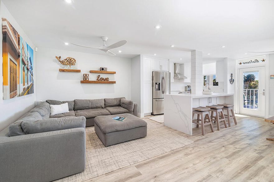 Imagine waking each day to gentle breezes and shimmering water views in your own coastal retreat. Introducing a fully appointed waterfront residence where design, comfort, and coastal lifestyle converge. Fully renovated and impeccably styled, this one-bedroom, one-bath home is a rare North Palm Beach offering, blending contemporary sophistication with the relaxed elegance and effortless seaside appeal that define waterfront living.

Offered fully furnished, the home is truly move-in ready and thoughtfully curated for comfort and style. Recent renovations enhance every corner, featuring custom kitchen cabinetry, striking quartz waterfall countertops, stainless-steel appliances, recessed lighting, new flooring and trim, fresh coastal-inspired paint, and smooth ceilings throughout A beautifully redesigned bathroom and an oversized bedroom with dual closets create the feel of new construction, while the added convenience of an in-unit washer and dryer found in only a select few residences, sets this home apart.

Impact windows invite an abundance of natural light, complementing the open-concept layout and subtle shiplap accents that evoke breezy waterfront living. Just outside your door, tranquil views of the Intracoastal Waterway and the Earman River provide a daily backdrop of shimmering blue horizons and gentle coastal breezes.

Paradise Harbour is a coveted boating community known for its relaxed atmosphere and marina lifestyle. Boat slips with lifts are available for rent or purchase when offered, making it ideal for boating and fishing enthusiasts alike. Residents enjoy a heated pool, welcoming clubhouse, and grilling area  perfect for sunset gatherings and leisurely afternoons.

Recent community improvements offer added peace of mind, including a new roof in 2024, A/C replacement in 2019, and a completed milestone inspection. This all-ages community also features low condominium fees, enhancing both value and appeal.

Perfectly positioned within walking distance to boutique shopping and waterfront dining, and only minutes from pristine beaches, I-95, the Florida Turnpike, and Palm Beach International Airport, the location allows you to arrive and immediately immerse yourself in the coastal lifestyle.

Whether you envision a serene year-round residence, a seasonal escape, or an inviting gateway into Florida waterfront living, this beautifully reimagined condo offers a rare opportunity to experience refined coastal living at its finest.