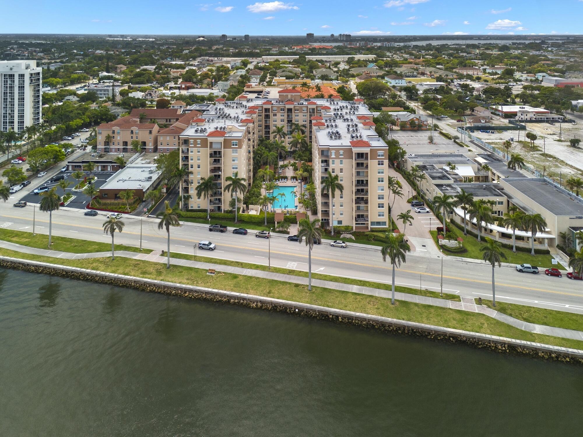 Rarely available -gorgeous top floor corner unit with volume ceilings & located in the quiet and cozy garden building of Flagler Pointe. Owner has recently installed wood laminate flooring, newer Central Air, new interior paint and impact windows/doors. Features include prime parking spot, spacious laundry room with extra storage, breakfast bar, and cozy balcony overlooking tranquil garden. This is a gated community with 24/7 full service concierge desk, in house management company, resort style pool, spa,sauna, gym and club lounge. Live the life of luxury with the newest Ritz Carlton Residence being built right next to Flagler Pointe. Great location right across the street from the intracoastal waterway. Close to downtown within biking and walking distance.