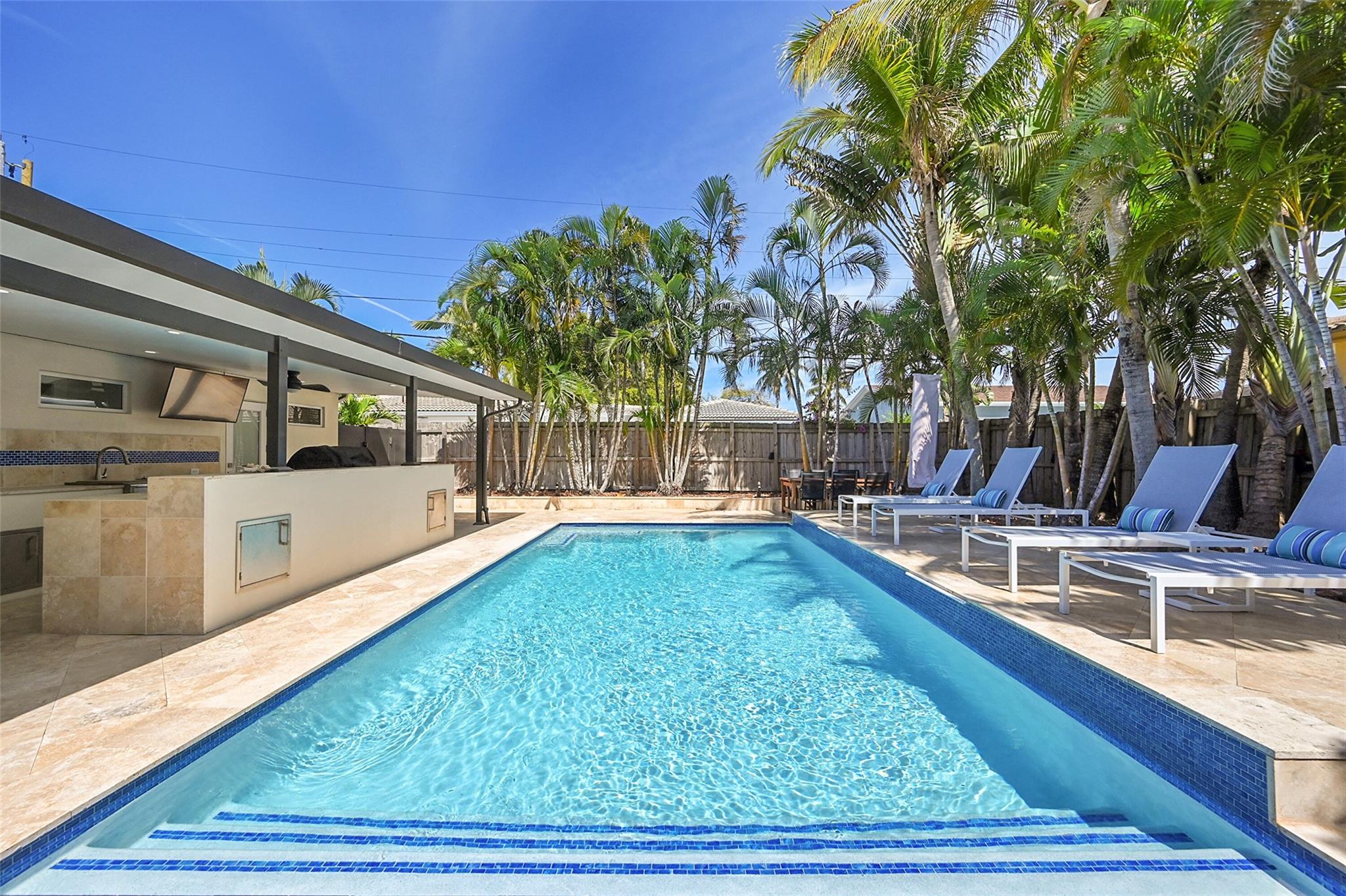 SELLER VERY MOTIVATED. BRING ALL OFFERS!!! Experience the Lauderdale-By-The-Sea Lifestyle! This beautifully renovated 3-bedroom, 3.5-bathroom home in Silver Shores is perfectly located between the ocean and Intracoastal Waterway. This residence features a designer custom kitchen with white shaker cabinets, quartz countertops with matching backsplash, stainless steel appliances, a gas range, an in-ground propane tank, porcelain flooring, impact windows & doors, a tile roof (2012), LG solar panels (2020) - electric bill at around $150 monthly.
Situated on an oversized corner lot with two driveways and a 2-car garage, private tropical backyard oasis with a new saltwater pool, outdoor shower, and a summer kitchen. Walk to the beach, shopping, dining, and vibrant nightlife.