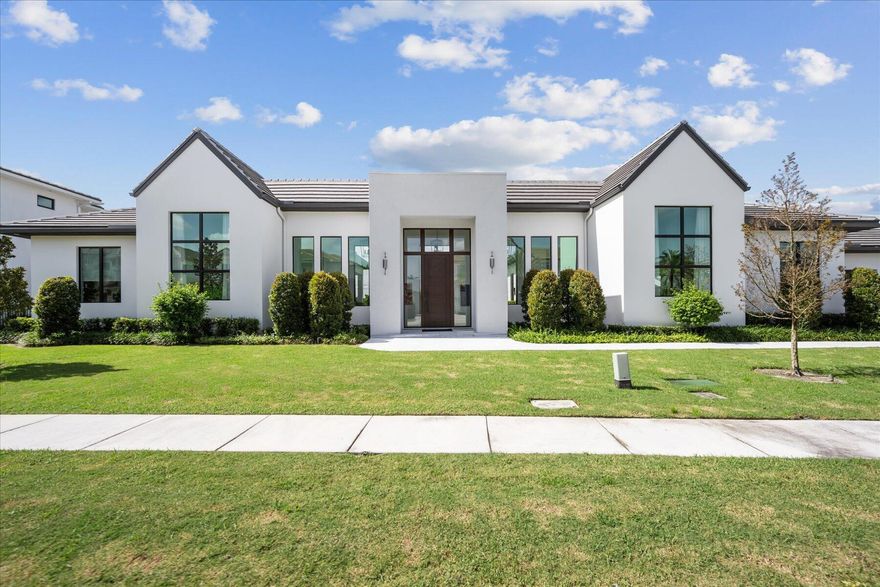 Bespoke estate, newer construction situated on a double lot in the gated golf community of Palm Beach Polo. Boasting a one-story contemporary facade, the home features 3,604 square feet of living space with 3 bedrooms, 4 full and one half bath, a private study, 2-car garage, and a luxurious pool area. With a design defined by a medley of inviting and intriguing elements, the masterminds at Soco Interiors left nothing to be desired with an inspiring organic-contemporary styled palette.The sophisticated incorporation of warm, rustic elements such as lofty open-beam ceilings and wide plank White Oak wood floors are paired with playful, modern features. This property offers an extraordinary living experience, seamlessly blending elegance and comfort.