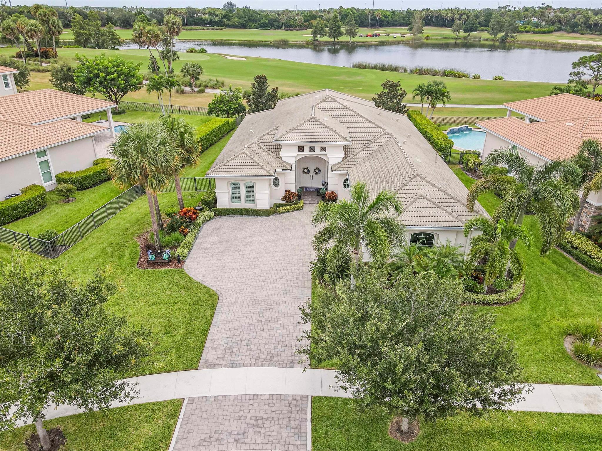 Live luxuriously & comfortably in this single-level Beaumont model with an ultra private homesite in the resort-style gated community of Jupiter Country Club. **FULL GOLF MEMBERSHIP is available immediately to the buyer of this home.** There is currently a long 3-5 year waitlist for this sought-after level of membership. (New owner can downgrade to social/club membership.) This home can be offered turnkey furnished-just bring your toothbrush! The open concept floor plan boasts 4 bedrooms, 3 1/2 baths, a flex room/den and a 3 CAR GARAGE. Privacy abounds from this prime location offering sweeping lake, fountain, golf course & tree-lined views with no homes in the rear. Oversized reverse-pie shaped corner lot with an enormous side yard. This home is beautifully appointed and provides all the