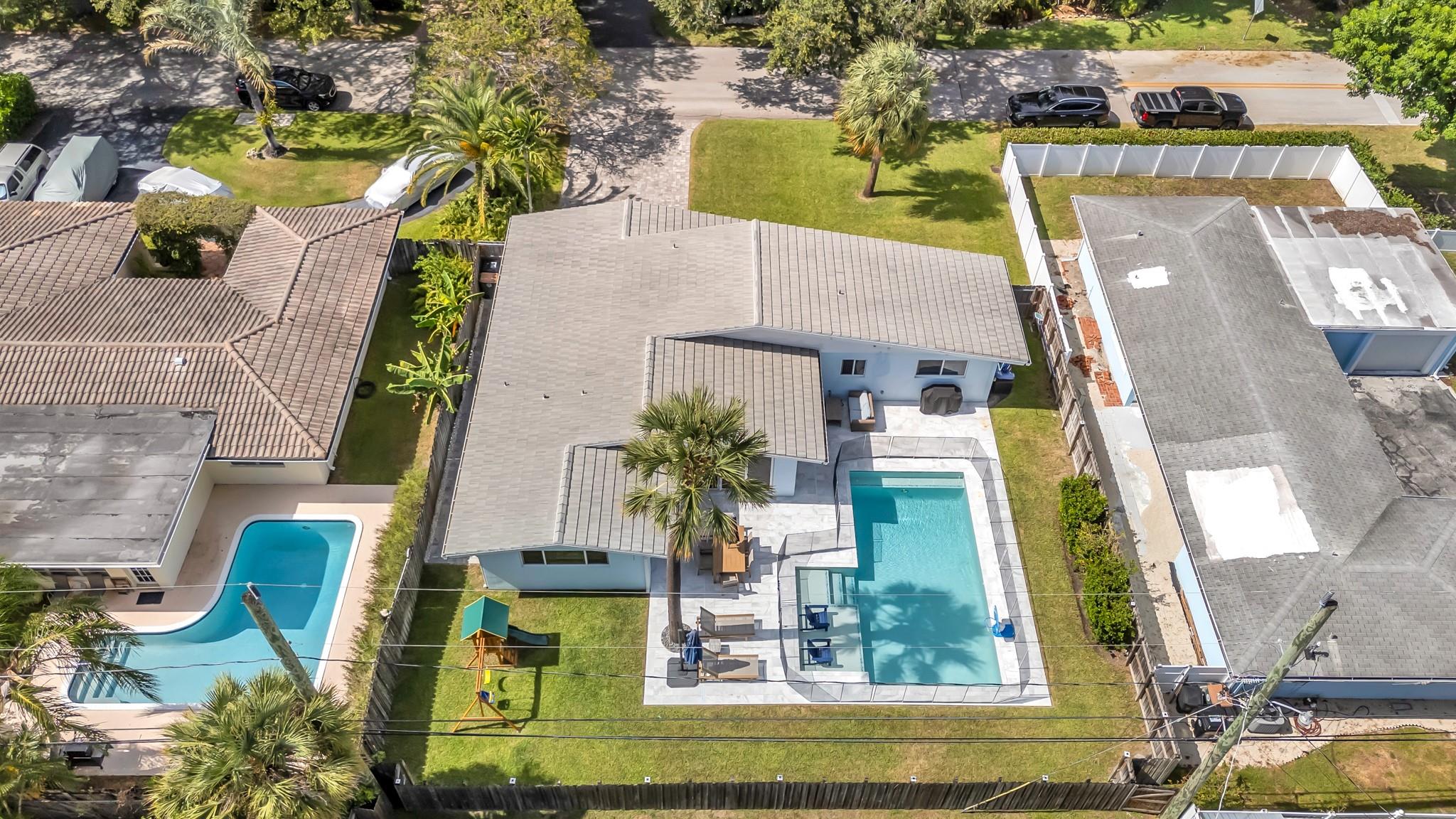 Fully renovated 3BD/2BA home on one of Lighthouse Point’s most desirable streets! This 1,750 sqft residence showcases an open-concept layout with modern finishes and timeless elegance. Interior features include a beautifully updated kitchen, spacious living areas, and upgraded plantation shutters. Step outside to a private backyard oasis with a brand-new heated pool, slip- and heat-resistant marble decking, 2023 roof, new gutters, new sprinkler system, and a covered outdoor dining area. The expansive, professionally landscaped yard offers privacy and tranquility. Prime location—just minutes from beaches, dining, nightlife, and both Pompano Beach and Deerfield Beach piers.