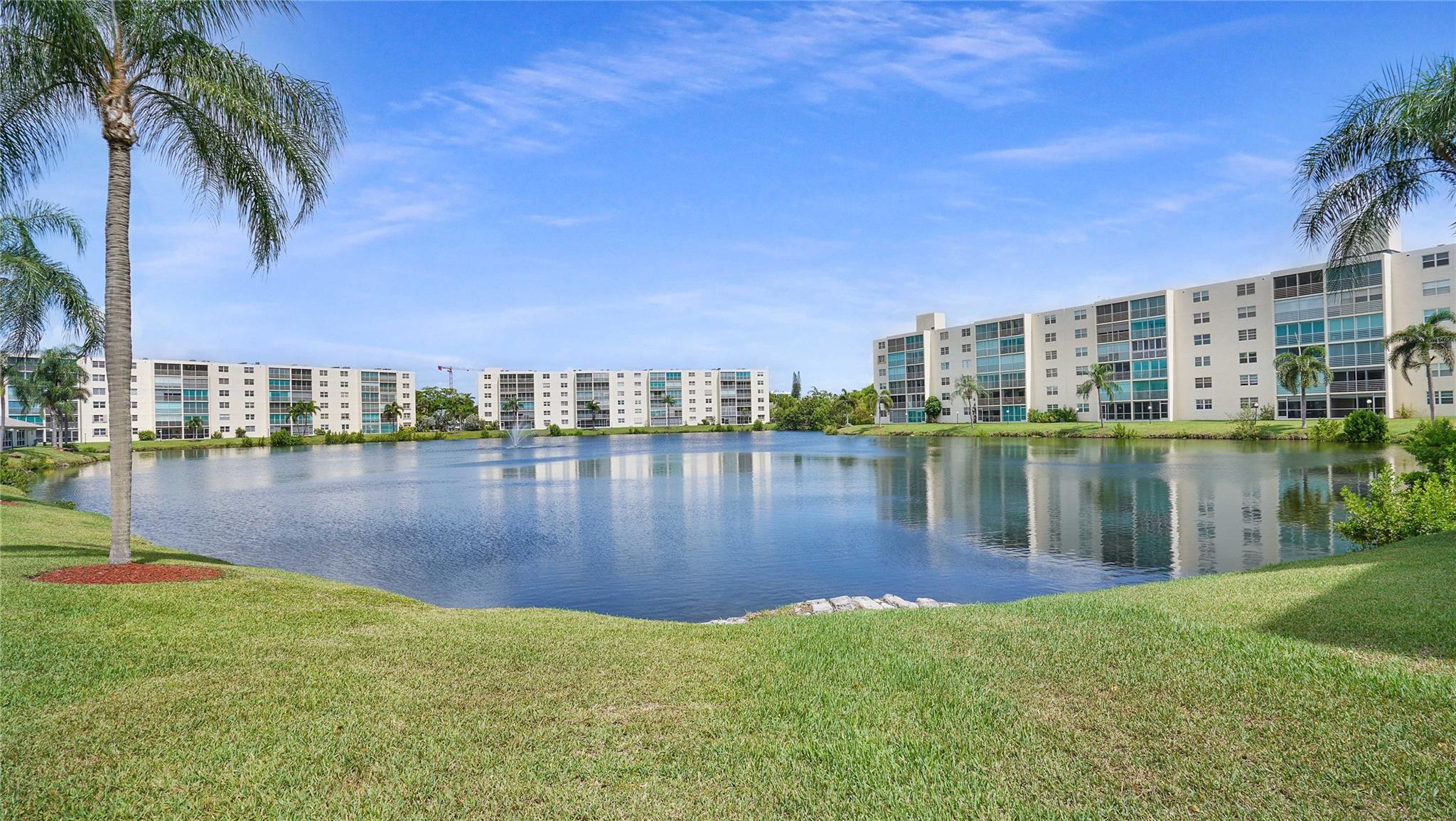 Totally renovated waterfront condo with stunning lake views in a quiet 55+ community, featuring tiles throughout, open kitchen with white custom kitchen cabinets, SS appliances, granite countertops, updated bathrooms with custom vanities, impact windows and door, close to shopping, banking, transportation, parks, ocean access. Located east of US 1 next to the Anne Kolb Nature Center and much more.