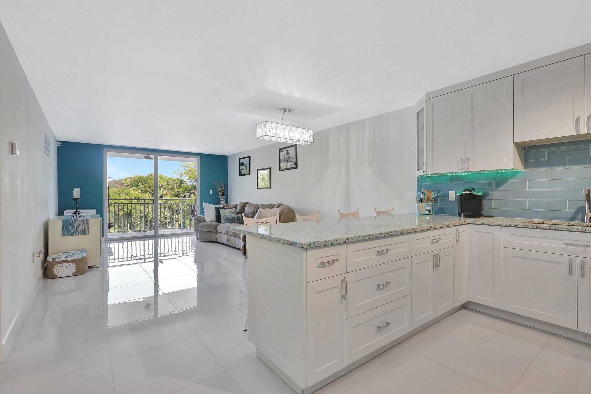 Fully Remodeled 1-Bed/1-Bath Condo with Immediate Rental Potential! This beautifully updated 1-bedroom, 1-bathroom condo is the perfect turnkey investment—rentable from day one of ownership on an annual basis. The unit has been thoughtfully remodeled with high-end finishes throughout, including:Full impact-resistant windows & doors for peace of mind and energy efficiency, Stunning vetrazzo countertops and soft-close cabinetry in the kitchen & bathroom, designer glass pebble and porcelain tile shower for a spa-like experience Sleek 24”x24” porcelain tile flooring throughout, and 2018 water heater. Unit also has rare feature of 2 deeded parking spots located directly in front of your private balcony. Whether seeking immediate rental income or a turnkey home, this unit checks all the boxes.