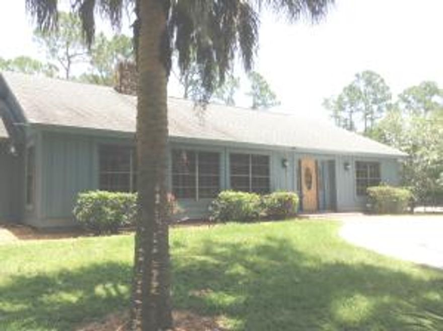 Quaint 3/2 home on beautifully treed lot.  Lot is high and dry.  Fresh paint and carpets on the inside.  Tile floors in living area, spacious kitchen. Skylights bring in natural light.  Fresh paint on the outside.  Shed on property.  Mango, lemon, grapefruit and orange trees.  Back of property is fenced. Screened pool and lanai.  Great location on paved road. About 2 miles from Indiantown Road and shopping.  Close to I95 and Turnpike.