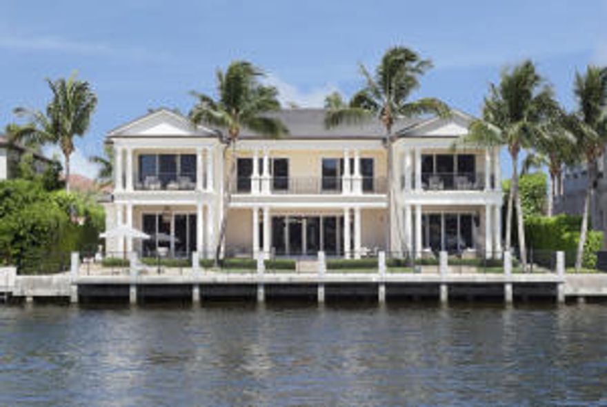 Directly fronting the Intracoastal on Royal Palm's signature street, this designer-furnished Georgian-inspired estate offers comfortably elegant South Florida living.Mastering a mix of traditional architecture and relaxed modern sophistication, this tropical Georgian-inspired estate stands on 100+/- feet of direct Intracoastal Waterway frontage on Royal Palm Way, the signature street of Boca Raton's world-famous Royal Palm Yacht & Country Club.  Designed by Affiniti Architects and constructed by luxury builder Mark Timothy, Inc., the six-bedroom residence gives classic style a chic, subtly glamorous inflection in designer-furnished interiors by Susan Connor of P&H Interiors which are featured in "Luxe Interiors + Design" magazine (Volume 12, #1).
