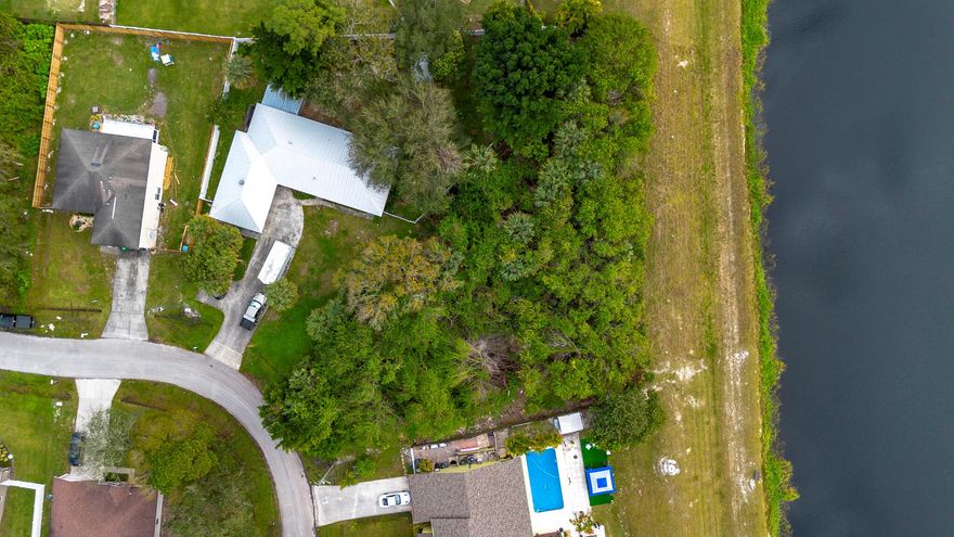 30K Price Reduction! Discover the perfect opportunity to build your dream home on this stunning 0.52-acre waterfront lot in Port St. Lucie! Boasting 160 feet of serene waterfront, this property offers a peaceful retreat with beautiful water views and endless possibilities for outdoor living. While there is no direct ocean access, the property is conveniently located just 8 minutes (2.8 miles) from a public boat ramp that provides ocean access for boating enthusiasts. Enjoy the added convenience of being only 9 minutes (4.3 miles) from Jessica Clinton Community Park, a vibrant recreational space featuring baseball fields, tennis courts, a basketball court, a BBQ grill, an outdoor calisthenics gym, and a playground for family fun.