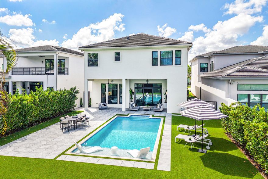 Welcome to a truly turnkey, designer finished masterpiece newly reimagined by MICHAEL GRAY INTERIORS in the prestigious Boca Bridges. Set on an expansive lot with no rear neighbors, this Sanibel model offers over 5,330 sq ft of refined living with 5 ensuite bedrooms and 6.5 baths. Elegant interiors showcase a striking porcelain accent wall, upgraded chef's kitchen, custom millwork, Google smart home integration, Lutron lighting, and Sonos sound throughout. The private backyard features a saltwater pool and serene outdoor living. Boca Bridges offers resort-style living with no club dues, including a 27,000 sq ft clubhouse, gourmet restaurant, resort pools, state of the art fitness center, tennis, pickleball, indoor and outdoor basketball, splash park, and more.