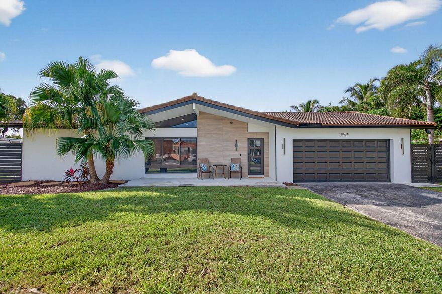 Remodeled and expanded with a modern flair, this house blends style and smarts!  Vaulted ceiling allows light to fill the home, showcasing new luxury plank vinyl flooring throughout, solid wood doors & level 5 smooth walls. Large central kitchen features new cabinetry, quartz countertops, new SS appliances, counter seating. Huge primary suite has a sitting room, its own AC, 2 custom closets, shower w/dual-temp shower heads. Full storm protection w/impact glass windows, hurricane rated garage door. Control 4 smart system enables app-controlled TVs, speakers & whole-home audio,70+ dimmable recessed lights, mechanical window blinds. Fortified roof is energy-efficient with closed-cell foam insulation. Full upgrade of electrical service including panel. No HOA, all work permitted.