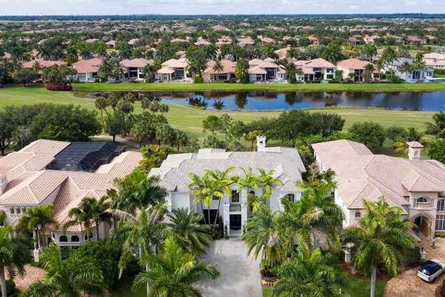 Exquisite, elegant, and modern luxury represents  which offers impressive golf course and lake views that are among the longest in this section of Mizner Country Club. A full 2020 renovation added sleek contemporary elements that make this estate in high demand.  Every room is abundantly spacious. This estate encompasses 6 bedrooms, including the 1st floor master suite and the 2nd floor Jr. master suite, 7 full bathrooms, 2 half bathrooms, and an office all spread over 7,369 sq ft underair and over 10,000 sq ft total. The double door entry offers dramatic first impressions and opens into a chic 2 story flyer with custom ceilings as well as a glass railing staircase. For entertaining the foyer area comes complete with a full built-in wet bar. The award winning gourmet kitchen is a dream for any chef. The 2020 kitchen upgrades include custom Italian modern cabinetry, wolf gas cooktop, and all new appliances. The kitchen features two large islands with quartz countertops and waterfall edges. The walk-in pantry offers custom shelving and cabinetry matching the kitchen. The estates other indoor features include an independent wine room, custom built-ins, and 30in x 60in porcelain and wood flooring throughout. 
For convenience, a residential elevator sweeps residents and guests to the upstairs 10ft with plenty of space for family and entertainment. The junior master suite and 3 additional suites are well placed for privacy.
The master suite which is featured downstairs, offers a separate sitting area, his and her master bathrooms, a spa like shower and soaking tub, finished with custom Italian cabinetry with lighted mirrors. The suite also includes his and her walk-in closets with custom floor to ceiling cabinetry.
Utility features are numerous including a two car garage attached to the home, a single car detached garage including single post hydraulic car lifts in each. Air conditioned garages, a full home generator, and security cameras are also included.
The lanai is its own private resort including a spectacular pool, oversized spa, lighted water features, porcelain pavers, and a full, custom outdoor kitchen. The covered outdoor patio is complete with automated phantom motorized screens. Finally, the estate is professionally landscaped with extensive outdoor lighting.