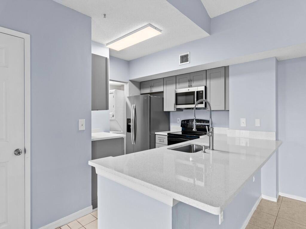 Vacant, clean, and move in ready! Welcome to Laguna of Vero Beach! Live and thrive in one of the most sought after condo communities in the area. Centrally located and nestled 5 -10 minutes from pristine beaches, dining and shopping. This unit offers a birds eye view of the active lifestyle community with resort style amenities. Step inside this totally remodeled two bedroom two full bath unit. This condo offers an unparalleled living experience with its beautiful finishes. With an open floor plan that blends the living, dining, and kitchen areas. With tile floors, new cabinets, quartz counter tops, and new appliances. This condo is ready for immediate move in.