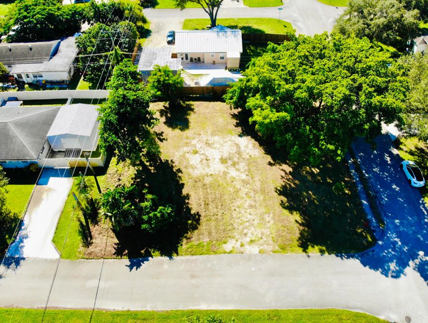 Nestled in a desirable non-HOA community ''Tropical Country Estates'' of Lake Worth, this oversized 1/4 acre high and dry corner lot offers an exceptional opportunity to build your dream home or investment property in a thriving community. With mature tropical landscaping and plenty of room for pool, expansion, or outdoor living, the canvas is wide open for your vision. Surrounded by a mix of well-kept homes and newer construction, the lot reflects strong neighborhood momentum. Just minutes from top-rated schools, shopping, dining, and turnpike.  Whether you're seeking privacy or convenience, this location delivers both. Secure one of the last vacant lots located in West Lake Worth today and imagine the possibilities your vision can bring to life.