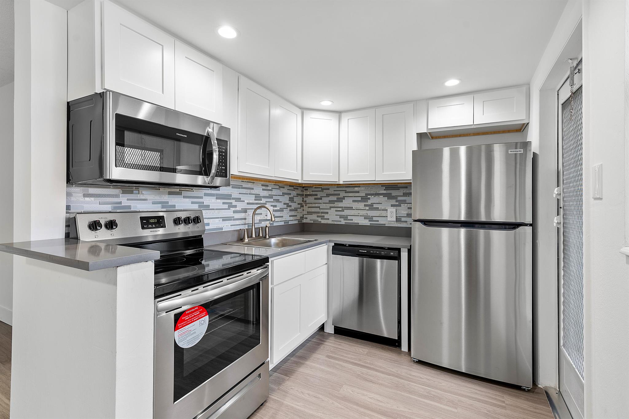 Bright, modern, and move-in ready! This beautifully updated first-floor 1-bedroom condo in a desirable 55+ Boynton Beach community offers luxury vinyl flooring throughout, a fully renovated kitchen with quartz countertops, white shaker cabinets, stainless steel appliances, and a stylish tile backsplash. The updated bathroom features a clean, contemporary design, while the in-unit washer/dryer adds convenience. Relax or work from home on the screened-in patio. One assigned parking space is located directly outside with plenty of guest parking available. The well-maintained community is close to shopping, dining, and just minutes from the beach. Full hurricane protection. 700 credit score required min.