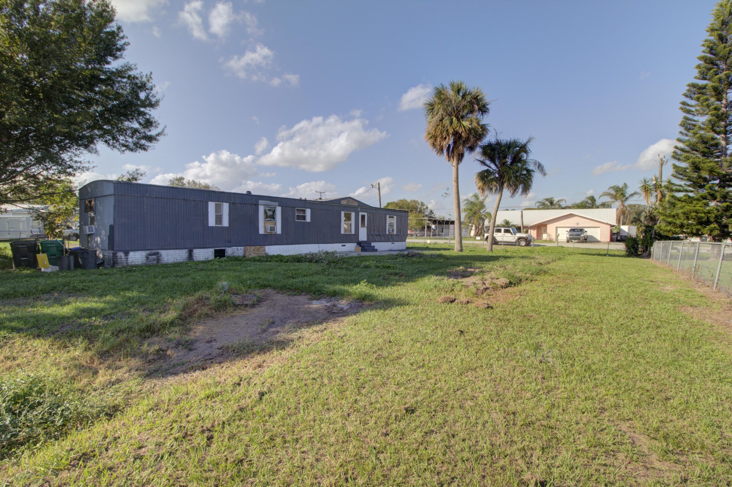Treasure Island - Canal front 3-bedroom mobile home on a flat, cleared, fenced lot in Okeechobee. This fixer-upper is currently leased for $1,000/month, offering great investment potential.