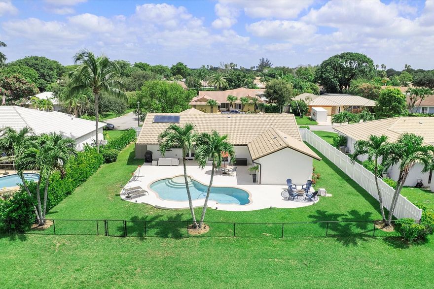 Renovated Waterfront 4 Bedroom 2 Bath with Pool! This spacious home features an Open Concept, Porcelain Tile throughout, Impact Windows & Doors, a Solar Hot Water Heater, and Volume Ceilings. The Chef's kitchen offers double ovens, granite counters, solid wood cabinets with loads of features for your convenience, stainless steel appliances, & a wine fridge. Primary Suite has amazing pool view, dual closets, & a stunningly renovated cabana bath with an enormous shower. You'll love how open & light-filled the home is throughout. A unique opportunity to add dock w/water access for boats/jet skis. It's situated on a quiet back street on a huge lot with lots of green space, an over-sized patio w/cool deck pavers, & a pool equipped w/saltwater option. Parks, shopping, Dining & more are close by.