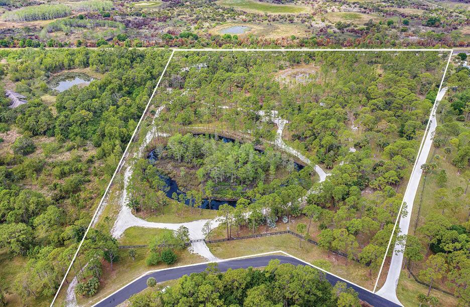Stunning 25 acre ranch with beautiful cypress paddock in the gated community of Ranch Estates in Ranch Colony. Ideal for both ranch and golf course living with the Dye Preserve a short walk away. Owner has plans from renowned architect Roger Janssen for approximate 8,500 sf of luxury living. Partially cleared and updated with new fencing, some drainage, expansive canopied storage with pavers, roads to newly completed firepit area with irrigation and generator for power at firepit. Bring your horses, toys, build a tennis court and more. Amazing property all in close proximity that Jupiter has to offer. Opportunity to buy their 4bedroom home on just under an acre built in 2019 and recently renovated and added onto for $2.995.000