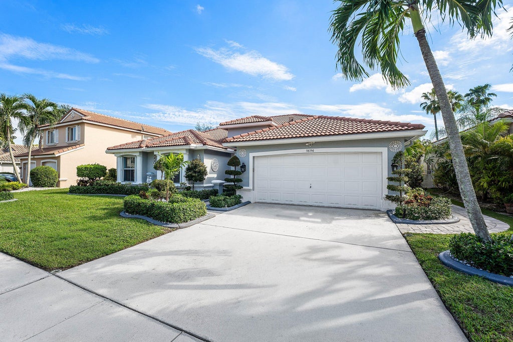 Photo of 5696 Muirfield Village Circle, Lake Worth, FL 33463 (MLS # B26088500)