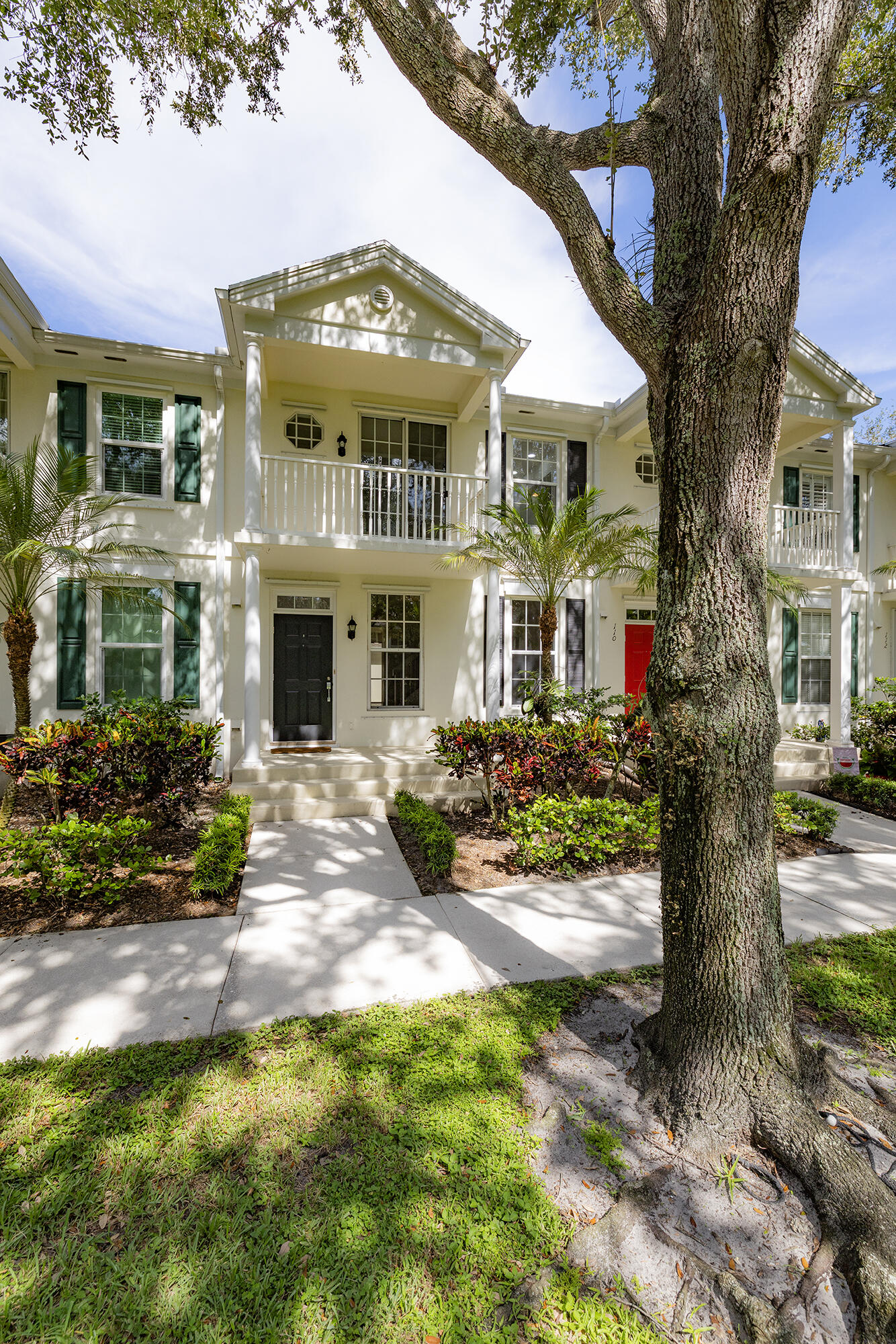 Located in the highly coveted Charleston Court neighborhood in Abacoa, this charming 3-bedroom, 2.5-bath townhome with a two-car garage offers 1,800 sq ft of comfortable living right next to the Abacoa Golf Course and Town Center. Enjoy a private balcony off the primary bedroom, a front porch overlooking green space with lake and golf course views, and a large private screened patio for relaxing or entertaining. Inside, you'll find two spacious living areas, freshly painted interiors, stainless steel appliances, updated light fixtures on the main level, and storage under the stairs. The primary suite boasts both a walk-in closet and a second standard closet, while the second bedroom also features a walk-in closet. Upgraded closet systems throughout provide maximum storage and organization