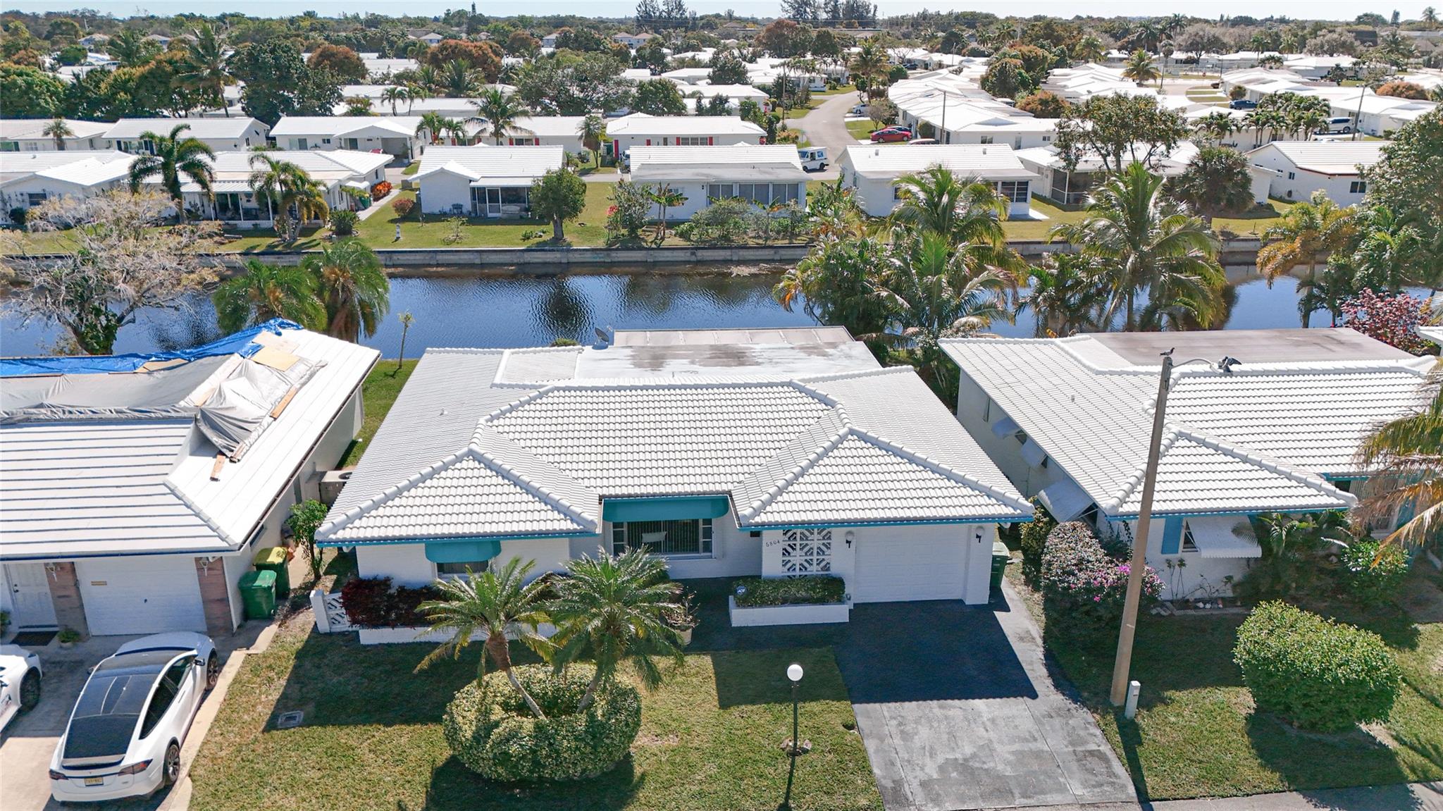 ***WATERFRONT***ONE OF THE LARGEST HOMES IN COMMUNITY ALMOST 1600 SQ. FT UNDER AIR***LIGHT & BRIGHT***2 BEDROOM/2 BATH***1 CAR GARAGE WITH DOUBLE WIDE DRIVEWAY***ACCORDIAN SHUTTERS FOR HURRICANE/STORM PROTECTION***LARGE FLORIDA ROOM OVERLOOKING WATER***SCREENED PATIO WITH ACCESS FROM FLORIDA ROOM ALSO OVERLOOKING WATER***EAT IN BREAKFAST NOOK***FOOD PANTRY***FULL SIZE WASHER/DRYER***ROOF 2012***A/C 2018***WATER HEATER 2024***WATER SOFTNER***LOW LOW MAINTENANCE OF $105 PER MONTH INCLUDES PAINTING OF HOUSE & ROOF, LAWN MAINTENANCE & SPRINKLERS***COMMUNITY CLUB HOUSE AND POOL***1 PERSON MUST BE 55+ (Mainlands 16-Forsythe)