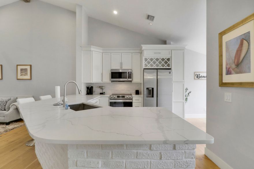 Enjoy paradise in this beautiful contemporary 2bedroom/2bathroom condo with one car garage at highly desirable community in Juno Beach. This spectacular vacation home has been completely remodeled with beautiful upgrades and all the modern luxury comforts. Hardwood floors and ceramic tile throughout. Large living area with vaulted ceiling leads to the kitchen and breakfast nook. In addition a separate dining area. The gourmet kitchen features stainless steel appliances and quartz counter tops. Motorized custom blinds in Master and Guest Bedrooms. Hurricane Windows installed recently. Rent includes water, sewer, trash removal, internet and basic cable.