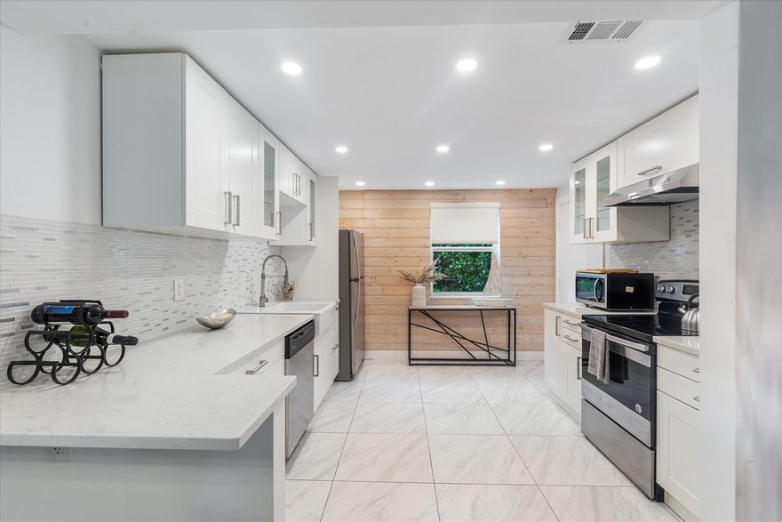 Beautifully renovated 2-bedroom, 2-bathroom condo in the heart of East Delray Beach — welcome to Unit 9 at Imperial Manor. This rarely available first-floor residence is nestled within a boutique building of only 12 units, offering the kind of intimacy and charm that simply can't be found in larger complexes.  Step inside and discover a thoughtfully updated interior featuring tile and bamboo flooring, plantation shutters, and impact windows throughout. The enclosed lanai adds valuable additional under-air square footage — perfect as a reading nook, home office, or sun-drenched sitting room — with a new hurricane-impact sliding glass door opening to a lush, serene courtyard. The kitchen is equipped with a convection microwave, and an in-unit washer and dryer adds everyday convenience.  This unit has been lovingly cared for by only two owners.  Major capital improvements give buyers peace of mind: a new roof (2024), fresh exterior paint (2024), and a community Aqua Pure water system, with additional improvements to asphalt, gutters, and sidewalks.   HOA fees cover common areas, building insurance, exterior maintenance, roof maintenance, and water.    The location is unmatched. You're just 1.5 blocks to the sand and surf, and 2 blocks to the vibrant energy of Atlantic Avenue — Delray's beloved Main Street lined with acclaimed restaurants, boutique shopping, art galleries, and year-round festivals.   Whether you're looking for a full-time residence, seasonal retreat, or income-producing investment, this is coastal Florida living at its most convenient and charming.