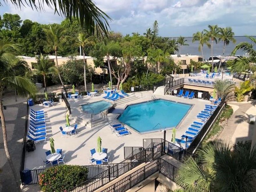 Waterfront Resort Living with a Boat Lift included at Deeded Boat Slip #11.  2 large bedrooms 1.5 baths, entrance space that could be a 3rd bedroom.  Located in the most desirable Moon Bay "B" building with an amazing 4th floor Waterfront and Pool view from an extra-large open balcony.  
Transferable Monroe County license for weekly vacation rentals included. VRBO #95325 for more information.  Includes over 35k in future vacation rental bookings.
HOA and Board are very strong with reserves at over 1 million dollars. Entire complex was recently painted and renovated with impact doors and windows, roofs, elevators, pool and clubhouse.  The community amenities include heated pool, clubhouse, tennis, pickleball, tiki hut, car charging stations, private beach, marina, fishing, jet ski docks