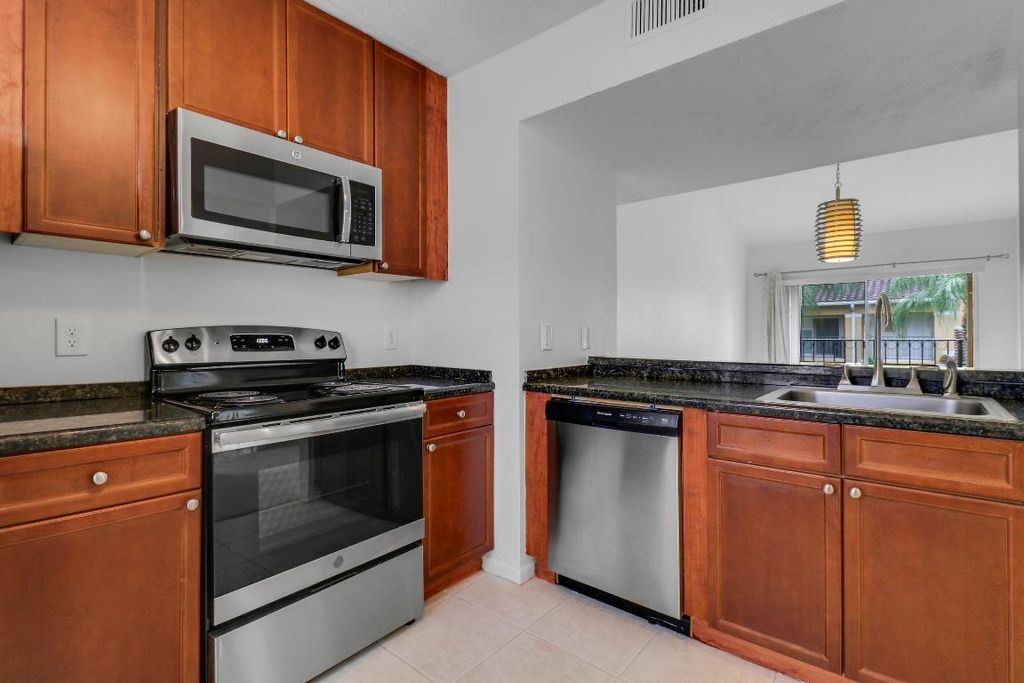 Photo of 1025 Lake Shore Drive #202, Lake Park, FL 33403 (MLS # R11128351)