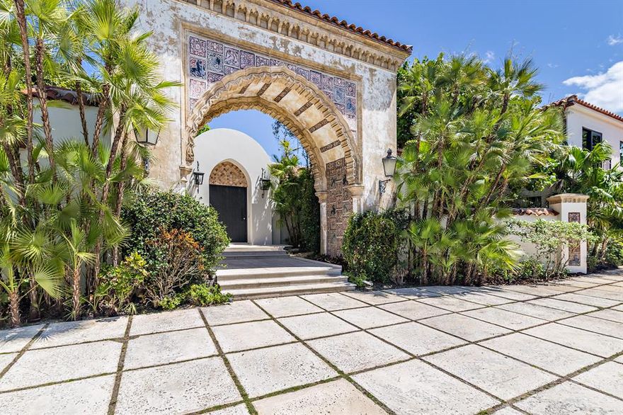 A rare offering of a significant Palm Beach property featuring the historic Fatio tiled entrance arch from the iconic Stotesbury Estate, ''El Mirasol.'' Located on an expansive 24,400+ lot and fully-renovated down to the studs, the six bedroom, seven and a half bathroom home offers a beautiful blend of the modern and traditional esthetic with carefully curated details and the most thoughtful finishes. The interior boasts over 12 foot vaulted ceilings, hickory wood flooring, Italian imported windows and custom doors throughout, dramatic living spaces, and a top-of-the-line chef's kitchen.  The first floor Master Suite is decadent in its expanse providing complete privacy, a spa-like bathroom, and a separate living area overlooking the pool. The second level features 11.5 ft ceilings with white-oak dramatic detailing and three generous bedrooms with ensuite bathrooms. The exterior of the estate is unique in that the property contains numerous specimen trees and private enclaves of garden space that truly immerses a guest in its island escape. The oversized cerulean-tiled pool and sweeping loggia are perfect for outdoor entertaining by the lazy palms and ample green space.Additional details include: an air-conditioned garage, full-house generator, summer kitchen, and reserved beach access.