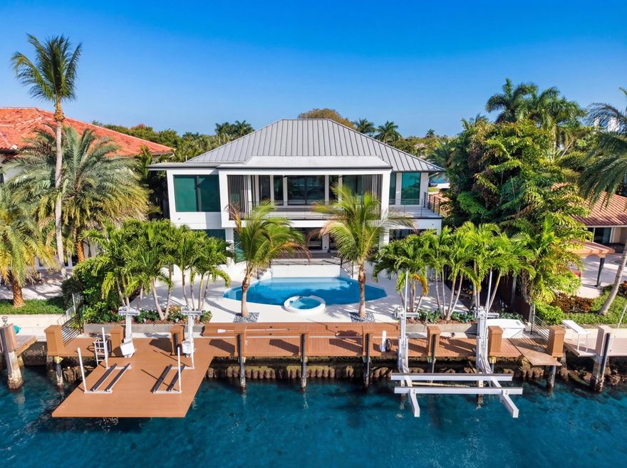 Modern Intracoastal Estate in the exclusive enclave of Hillsboro Shores with private beach access and fronting 75'+/- on the wide intracoastal waterway just minutes away from the Hillsboro Inlet.