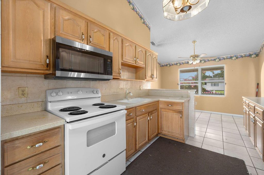 Photo of 301 SW Whitmore Drive, Port Saint Lucie, FL 34984 (MLS # R11098563)