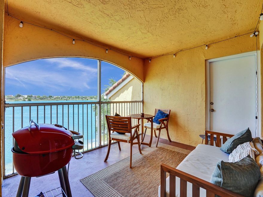 Your private retreat awaits in the prestigious gated community of Sailboat Point. This 2-bedroom, 2-bathroom residence showcases breathtaking lake views from the moment you enter. The thoughtfully designed open-concept layout, enhanced by renovated flooring and tastefully updated baths, creates an ideal setting for both relaxation and entertaining. The living space extends onto a spacious screened-in patio, offering a peaceful backdrop for morning coffee or evening sunsets over the water. For added convenience, a washer and dryer are located within the unit. Residents enjoy an active lifestyle with access to a pool, fitness center, tennis courts, pickleball, and a community boat dock. This secure, pet-friendly enclave is impeccably managed and offers generous guest parking.