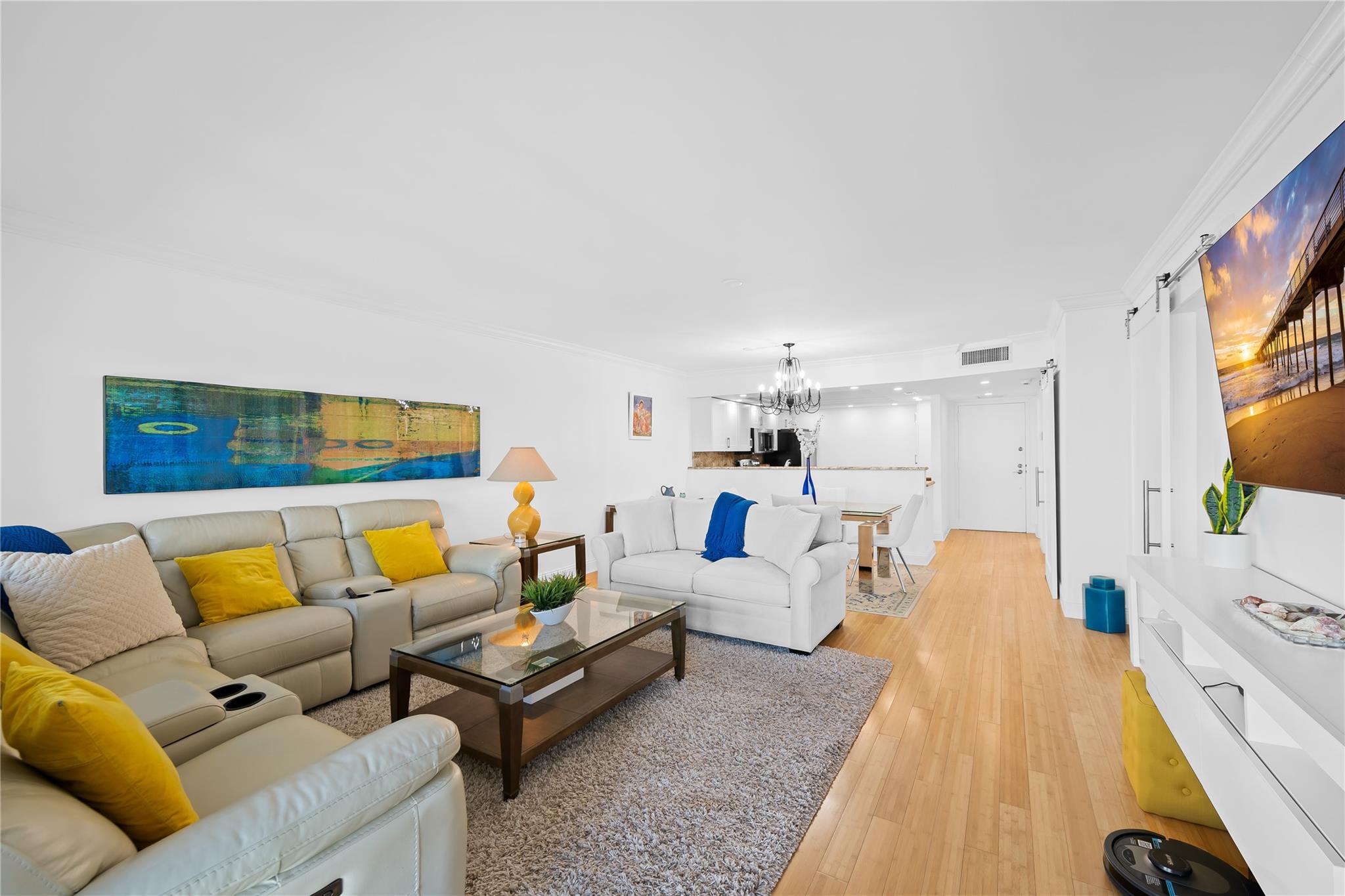 One-of-a-kind, turnkey beachfront condo in the highly desirable Sea Ranch Club. Fully renovated and thoughtfully redesigned, this spacious residence features a large primary suite, added den, and two full bathrooms. The open kitchen with granite countertops, stainless steel appliances, and recessed lighting is perfect for entertaining. Light engineered wood flooring throughout, Primary bath offers double sinks & a modern jacuzzi tub/shower combo. Enjoy spectacular ocean views from the balcony. Impact windows and doors throughout. Additional highlights include a full-size washer/dryer and extra storage. Sea Ranch Club offers resort-style living with three pools, two gyms, tennis courts, 2 dog parks, cabanas, herb gardens, and direct beach access. Walking distance to Publix, shops & more.