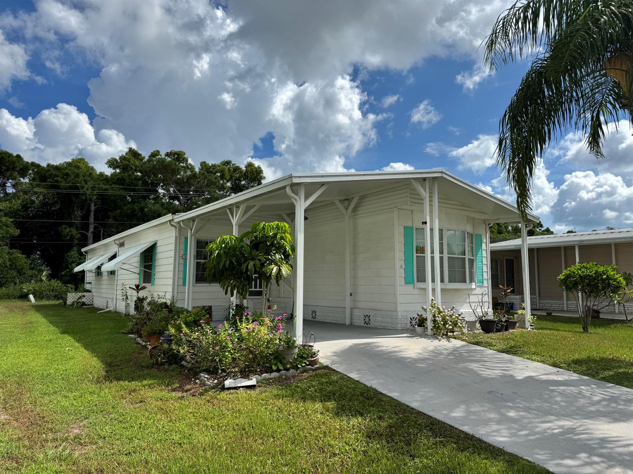 Spanish Lakes Golf Village, Acitve 55+ Community! Affordable Two Bedroom, Two Bath, Carport with large living room, and family room. Spacious kitchen w/appliances. There is a laudry room and includes washer / dryer. Large screened porch on the back. Great location just minutes to shopping and area beaches. Spanish Lakes is a land lease community with hoa/lot rent $800 per month and includes fantastic amenities such as a 9-hole golf course, pool, clubhouse, tennis courts, and more! Enjoy meeting new friends and taking part in the many monthly social events hosted by the residents.