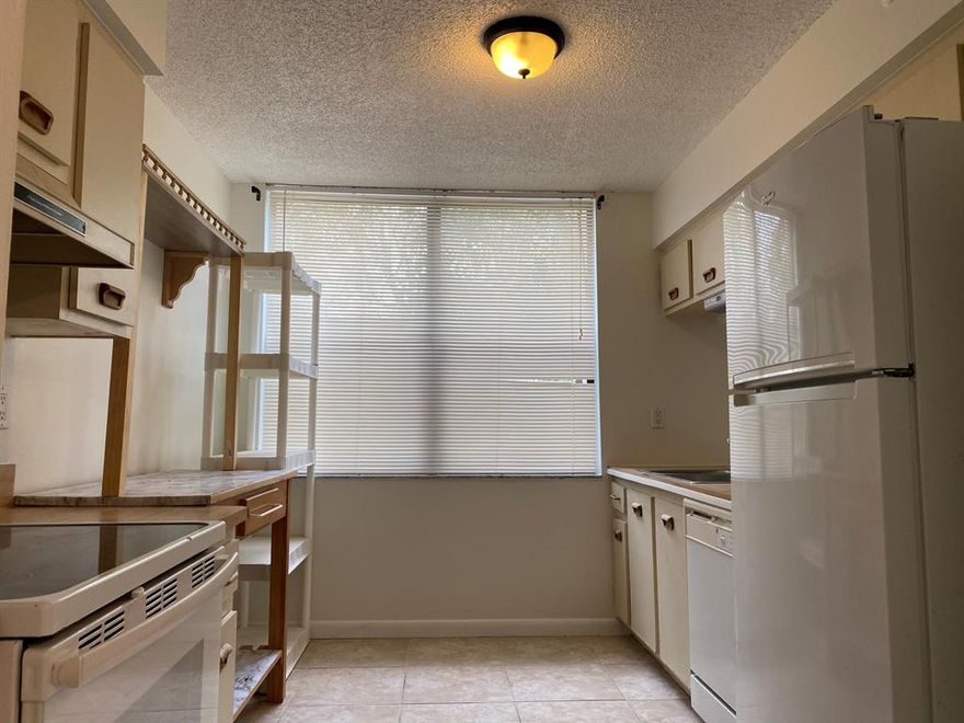 This spacious south facing corner unit enjoys natural sunlight all day and has a huge wrap around balcony overlooking the fountain and lake to watch the sunset from. The generous layout has a laundry room/utility room in the unit, jack & Jill bathroom and oversized kitchen. Located in an energetic ALL AGES community with fitness center and 2 pools. Close to shopping, dining, public transportation and. just 5 minutes to the beach.