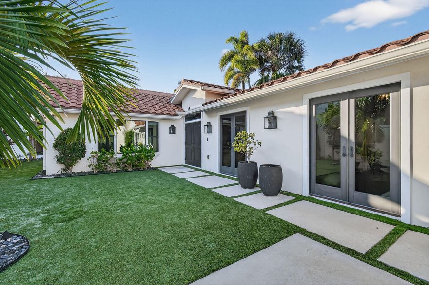 Experience refined coastal living in this stunning custom re-built beach compound. The thoughtfully designed floor plan offers 3 bedrooms, 3.5 baths, a welcoming living room, and a versatile media room/4th room with a full en-suite bath, wet bar, and full-size wine refrigerator--perfect for entertaining or making it the primary bedroom. The re-build included raised ceilings throughout with wood accent beams enhancing the architectural character, while European wood floors, a gourmet kitchen with high-end appliances, gas range, and Moroccan-inspired mosaic tile in the kitchen and baths elevate the interiors. A custom two-car garage addition has been architecturally planned to complement the home's design with 3D renderings & engineered drawings available. The garage infrastructural considerations to include plumbing and electrical hook up to allow additional living space if desired. Construction has not yet commenced, offering the Buyer flexibility. 
Enjoy complete privacy in the beautifully landscaped backyard featuring a pool and infinity-edge spa. A true oasis within the gated community of Ocean Walk. *Some pictures are virtually staged, 2 Car Garage renderings available upon request.